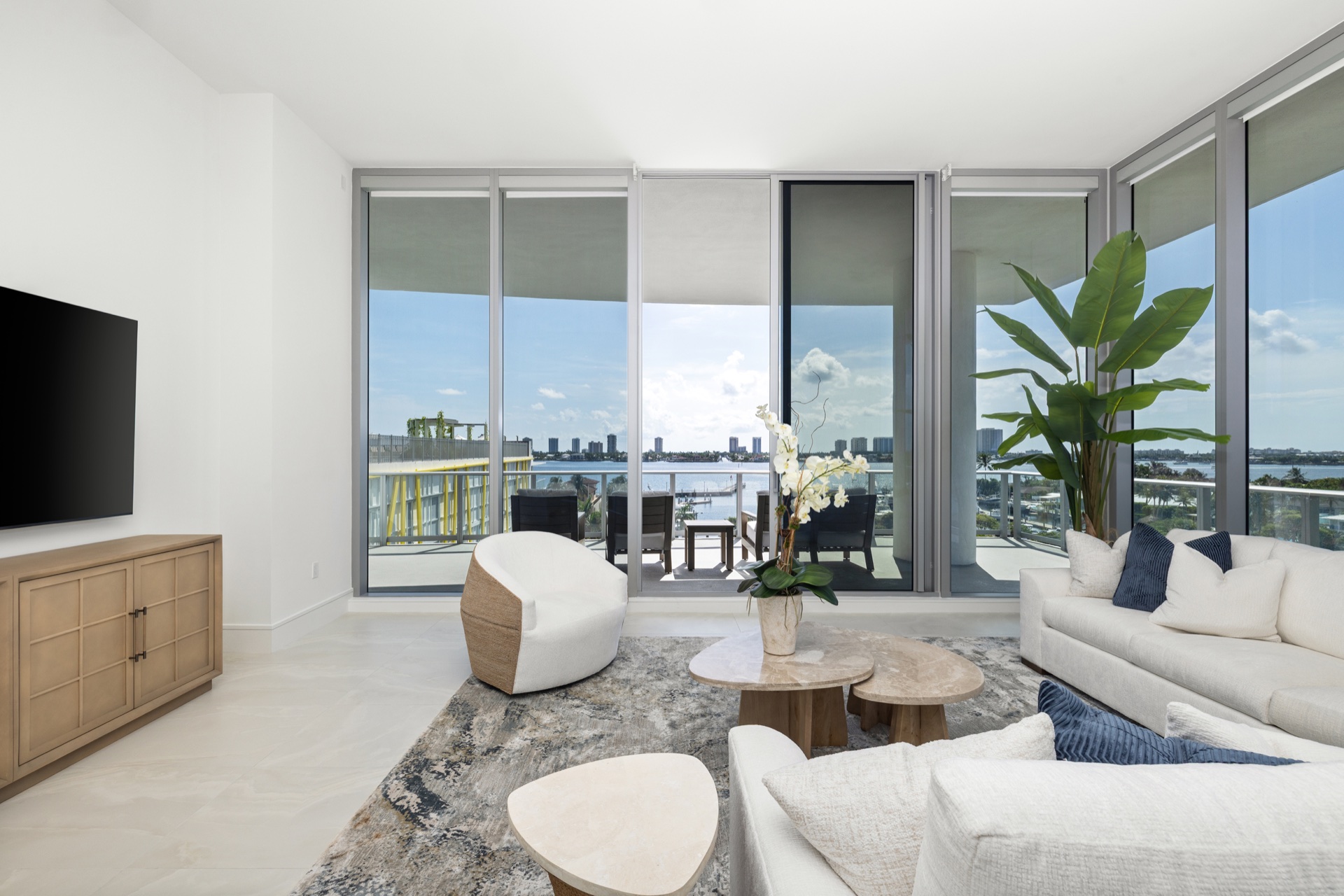 Fully furnished living room in Residence 612 with wraparound waterfront views