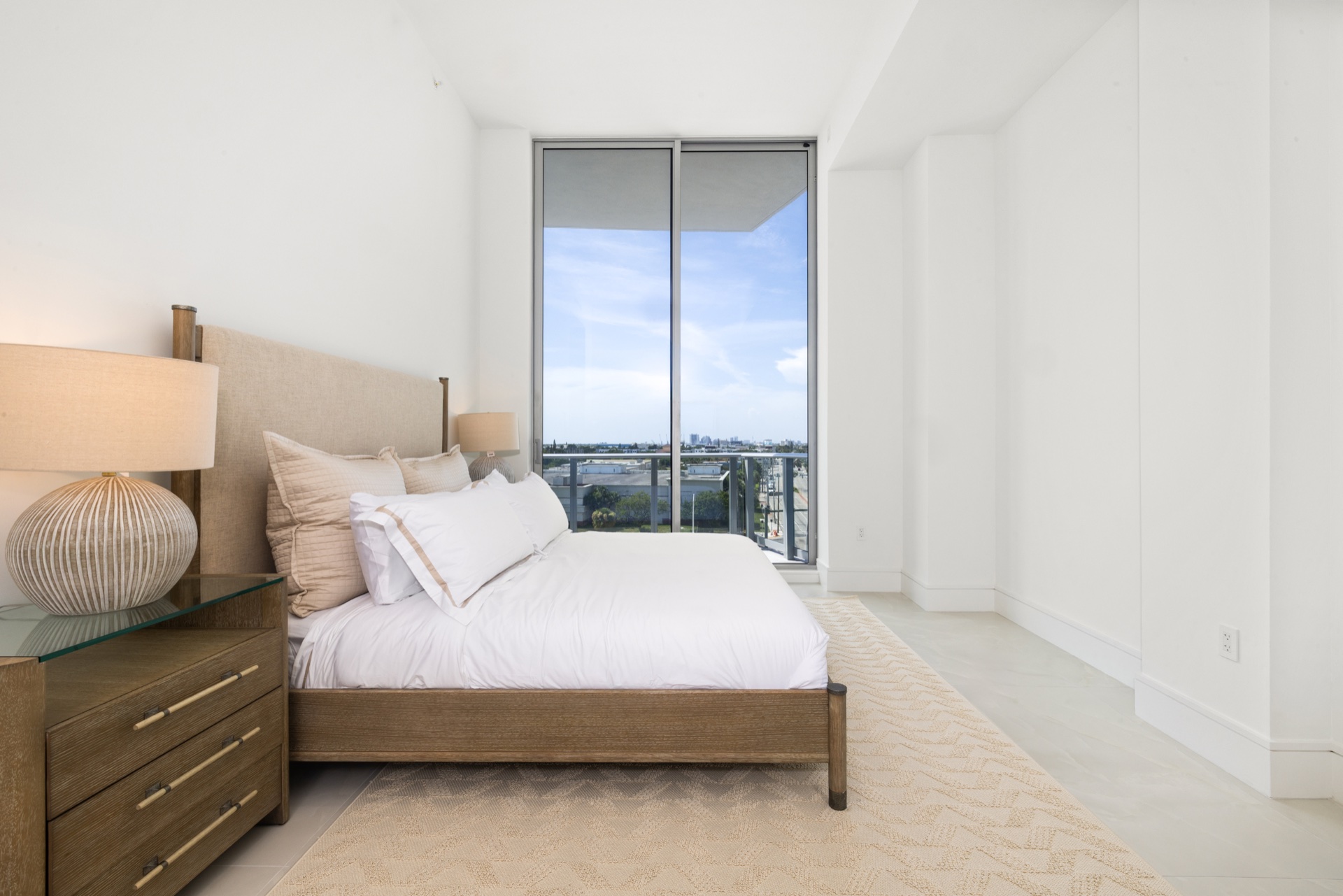 Fully furnished guest bedroom with a private waterfront outlook in Residence 612